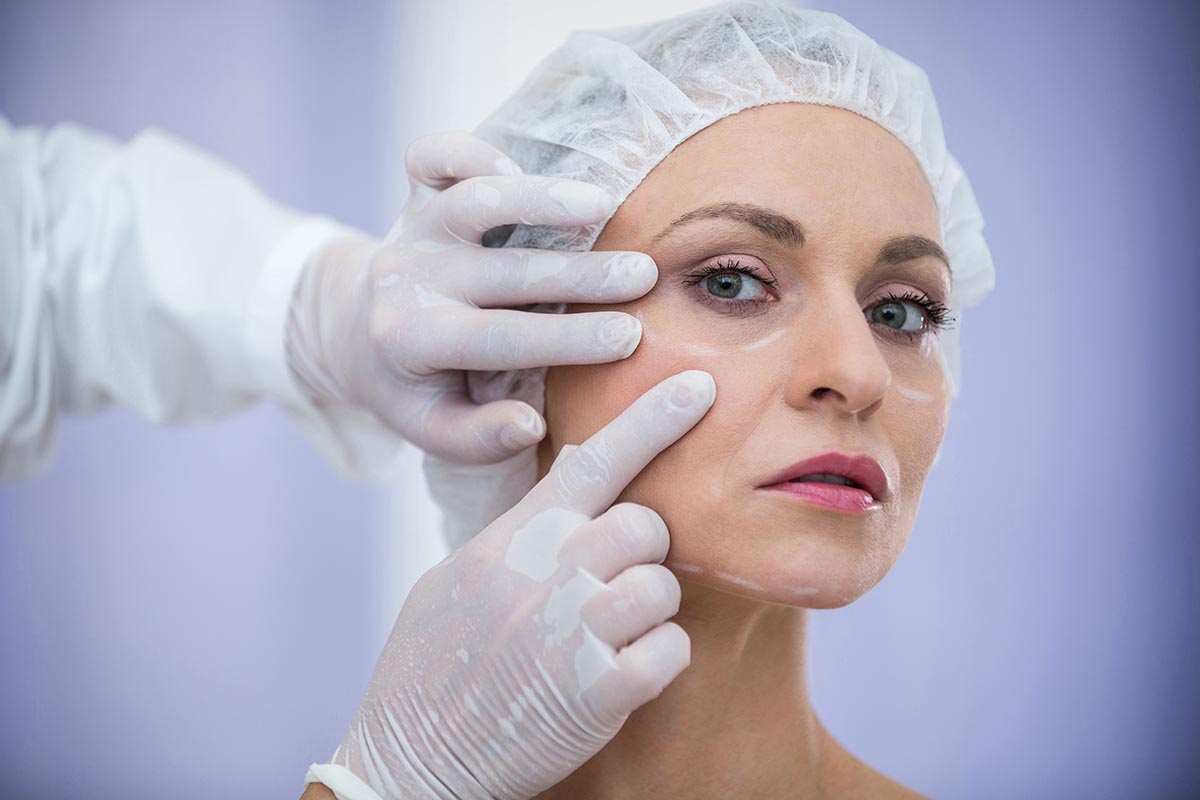 doctor-examining-female-patients-face-cosmetic-treatment.jpg